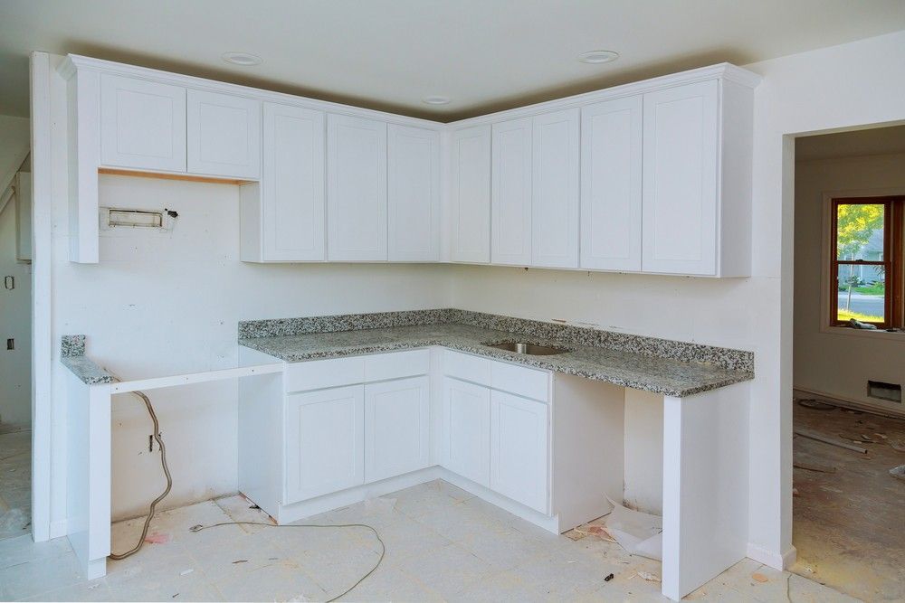 A Kitchen Under Construction With White Cabinets — Elite Stone in Tweed Heads South, NSW