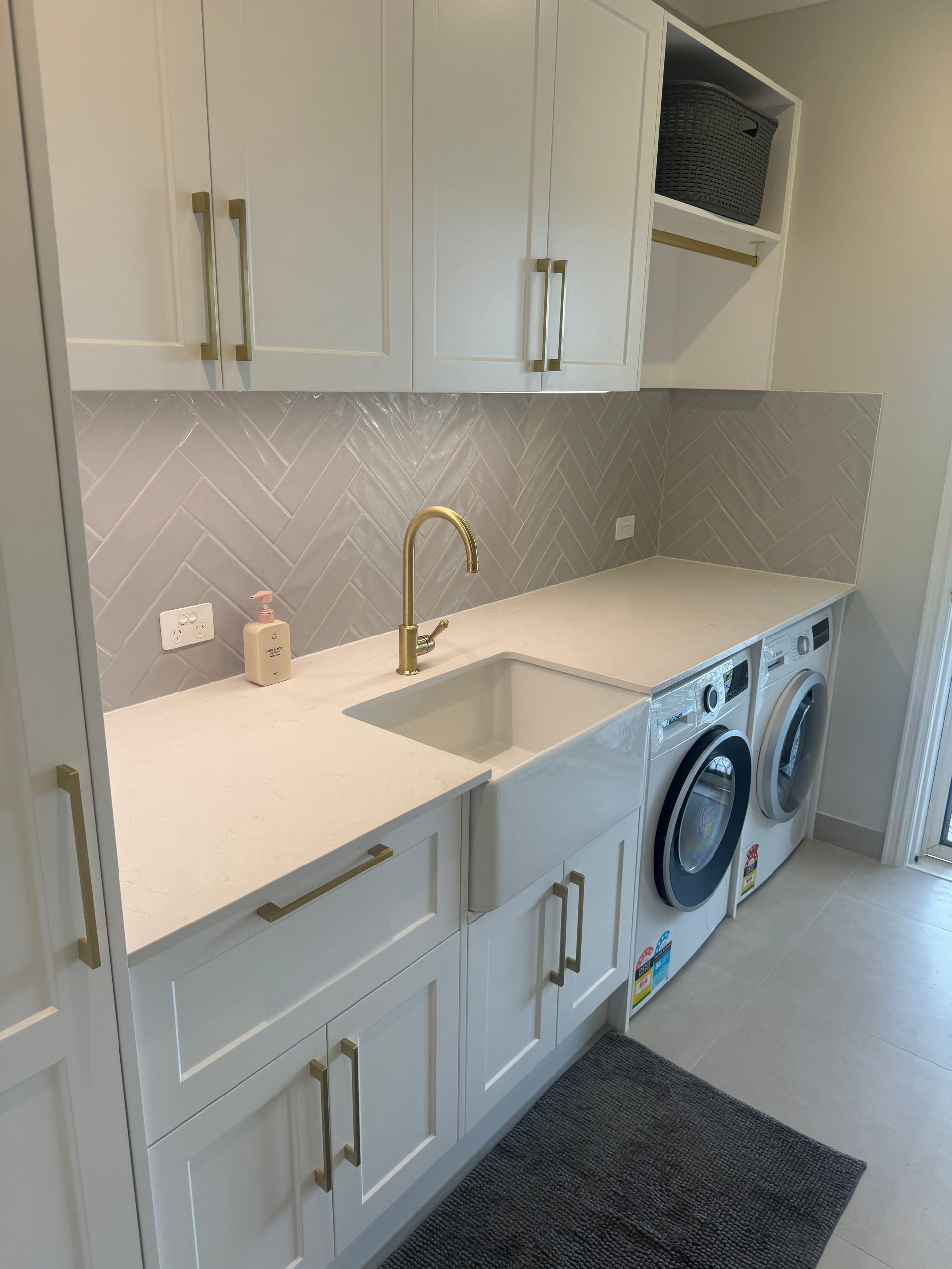 A Laundry Room With Blue Cabinets, a Washer and Dryer — Elite Stone in Tweed Heads South, NSW