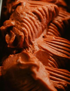 A close up of a container of chocolate ice cream.