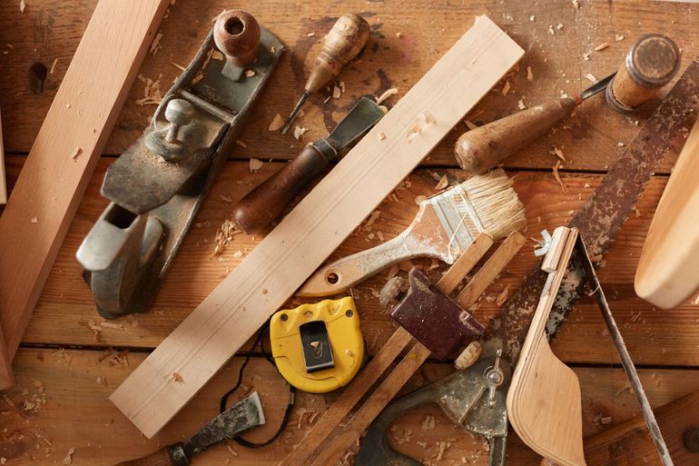 A wooden table with a lot of tools on it