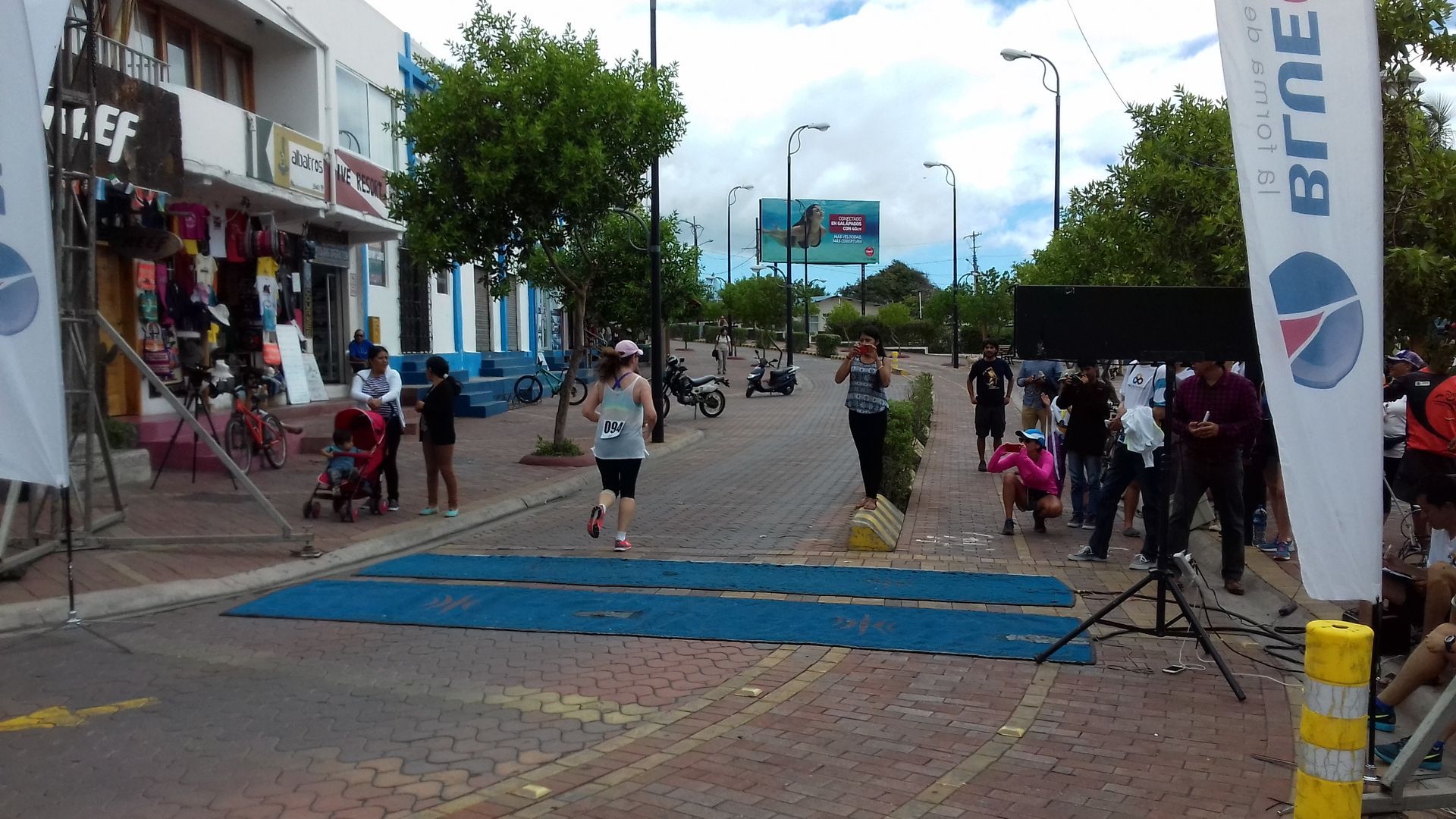 A person running on a street in the Galapagos 10K