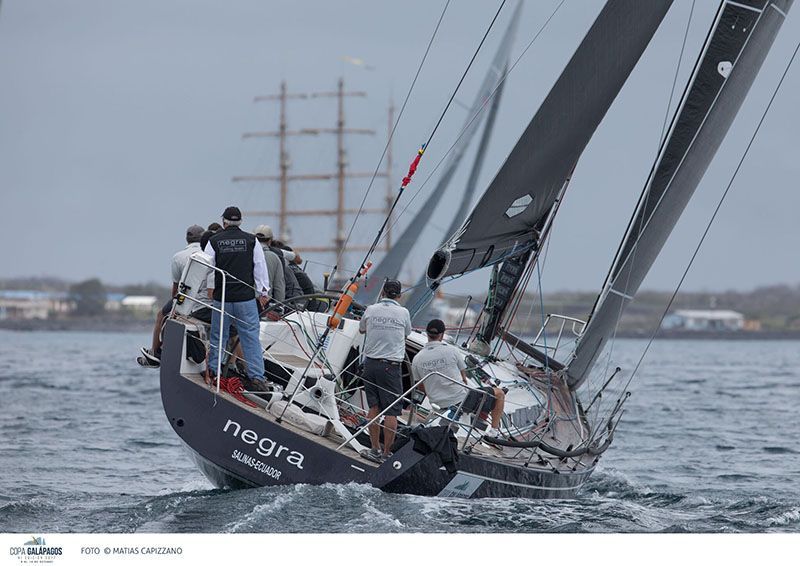 A group of people are on a sailboat in the ocean in Galapagos.