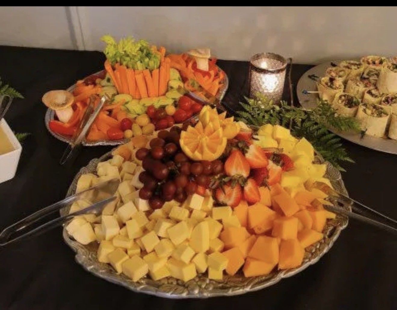 A table with plates of food and a bowl of salad on it