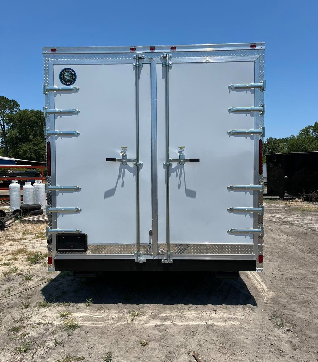 White enclosed cargo trailer with double doors, latches, and hinges.