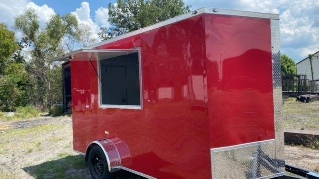 Red food trailer with a serving window.
