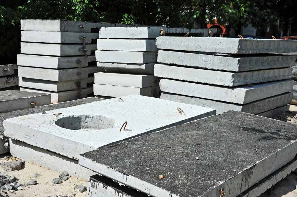 Stacks of Gray Concrete Slabs, Some With Holes, Outdoors — Easy Mix Concrete In Erina, NSW