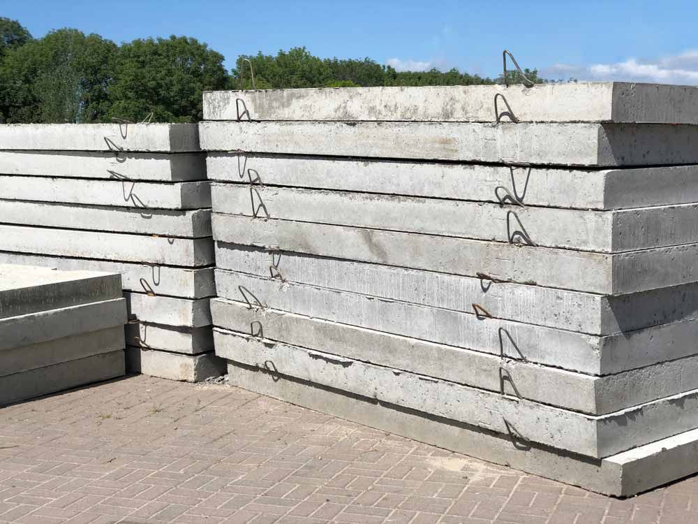 Stacks of Rectangular Gray Concrete Slabs With Metal Loops — Easy Mix Concrete In Wyong, NSW