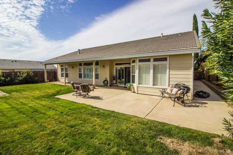 Backyard Patio With Lawn, Tan House — Easy Mix Concrete In Charmhaven, NSW