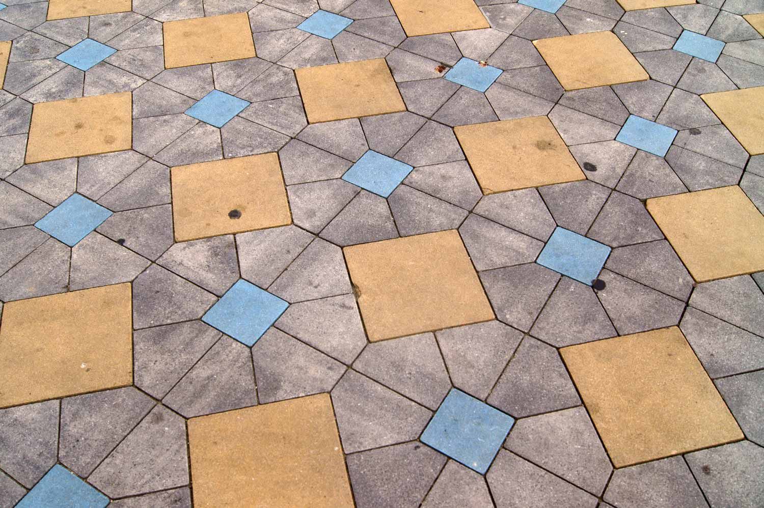 Paved Ground With Tan and Blue Square Tiles Surrounded by Grey — Easy Mix Concrete In Charmhaven, NSW