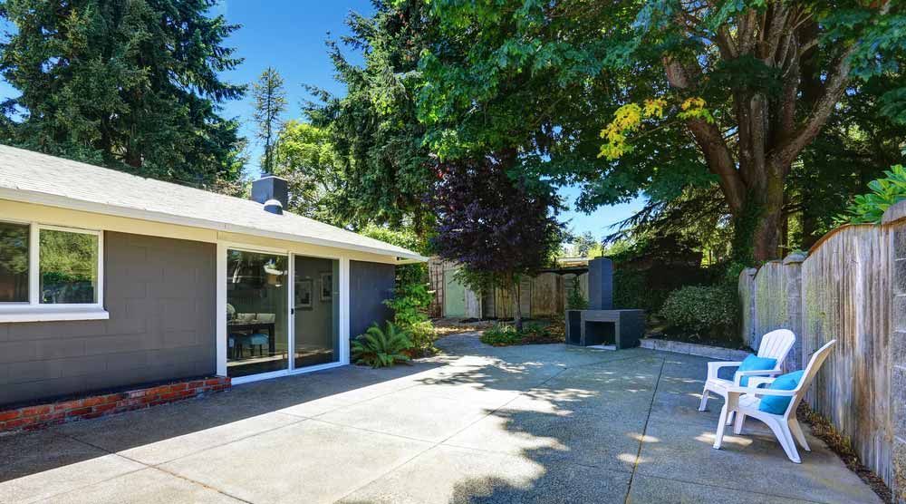 Backyard Patio With Gray House, Trees, Concrete — Easy Mix Concrete In Gosford, NSW