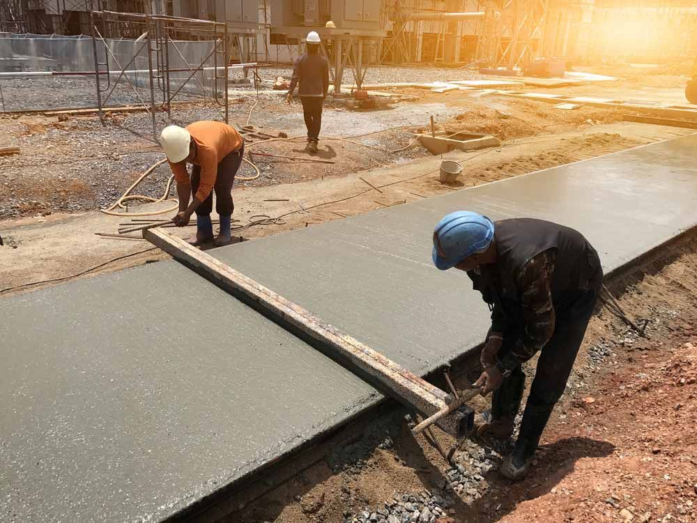 Construction Workers Leveling Wet Concrete — Easy Mix Concrete In Woy Woy, NSW