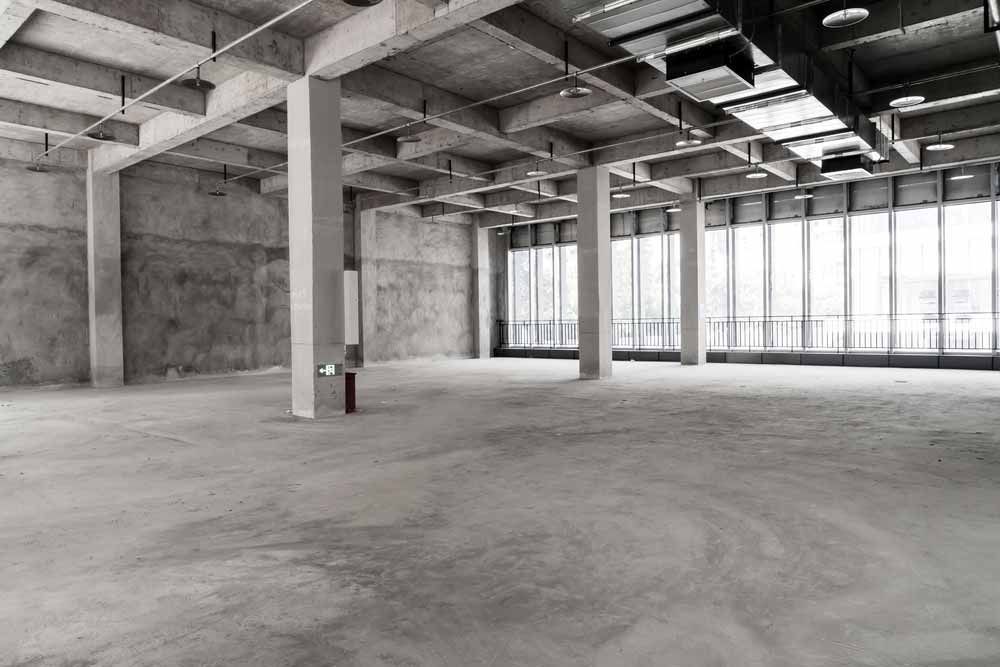 Empty Concrete Interior of a Building, With Pillars and Large Windows — Easy Mix Concrete In Erina, NSW