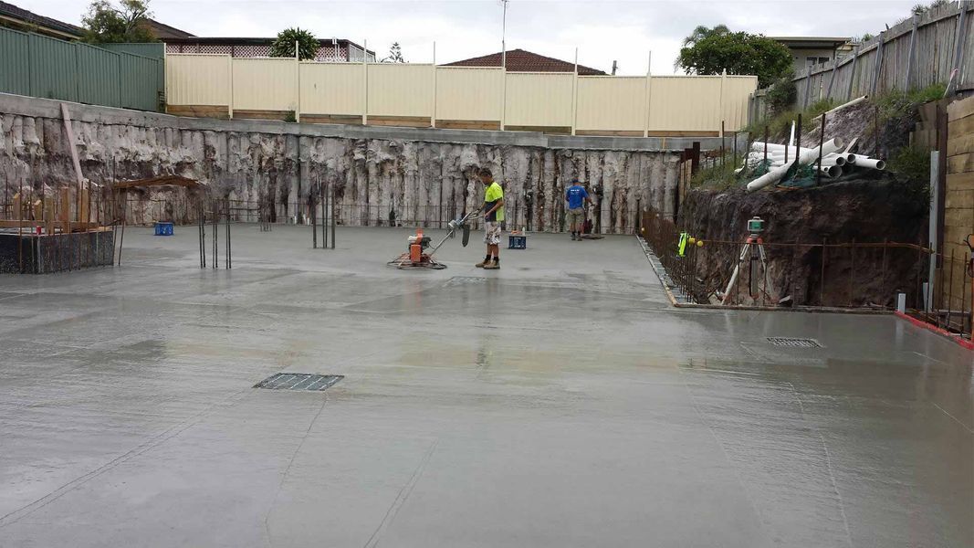 Construction Workers Pouring Concrete at a Construction Site — Easy Mix Concrete in Berkeley Vale, NSW