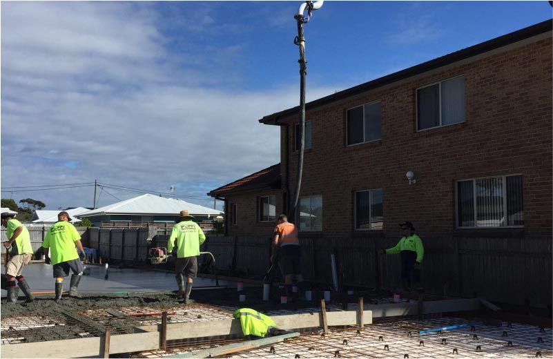 Construction Workers Pouring Concrete at a House — Easy Mix Concrete in Berkeley Vale, NSW
