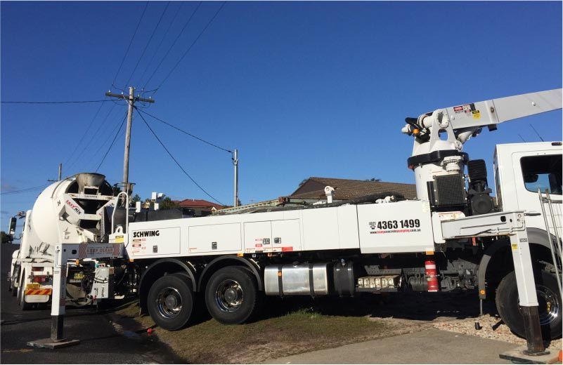 White Cement Truck With Crane Parked on a Curb — Easy Mix Concrete In Berkeley Vale, NSW