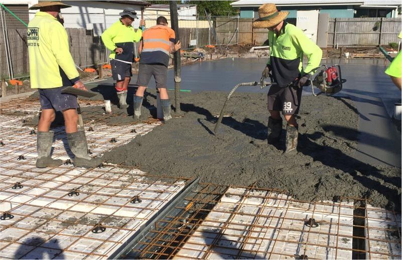 Construction Workers in Green Pouring Concrete — Easy Mix Concrete In Gosford, NSW