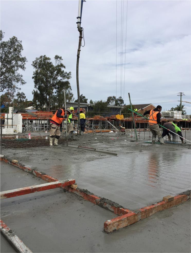 Construction Workers Pouring Concrete on a Building Floor — Easy Mix Concrete in Berkeley Vale, NSW