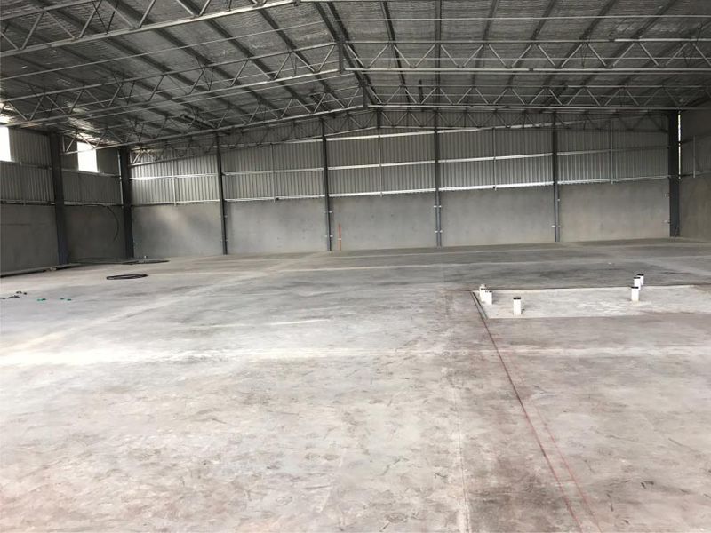 Empty Industrial Warehouse Interior With Concrete Floor — Easy Mix Concrete In Central Coast, NSW