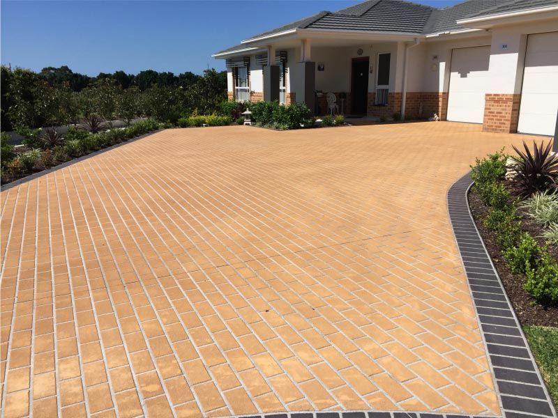 Tan Brick Driveway Leading to a Light-coloured House — Easy Mix Concrete In Central Coast, NSW