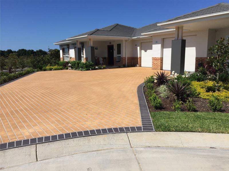 Beige Brick Driveway Leads to a Light-coloured House — Easy Mix Concrete In Berkeley Vale, NSW