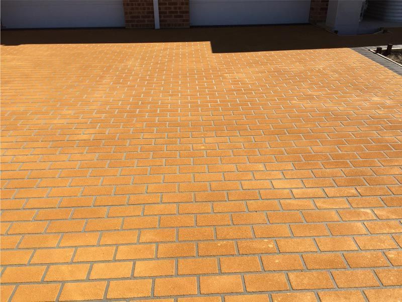 Brick Driveway, Golden-yellow Pavers, Leading to a Garage — Easy Mix Concrete In Berkeley Vale, NSW