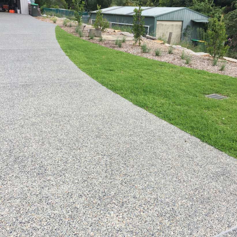 Gravel Driveway Curves Beside a Green Lawn — Easy Mix Concrete In Woy Woy, NSW