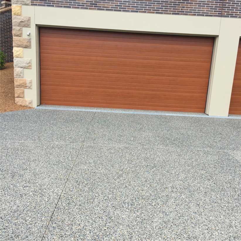 Brown Garage Door With a Concrete Driveway — Easy Mix Concrete in Berkeley Vale, NSW