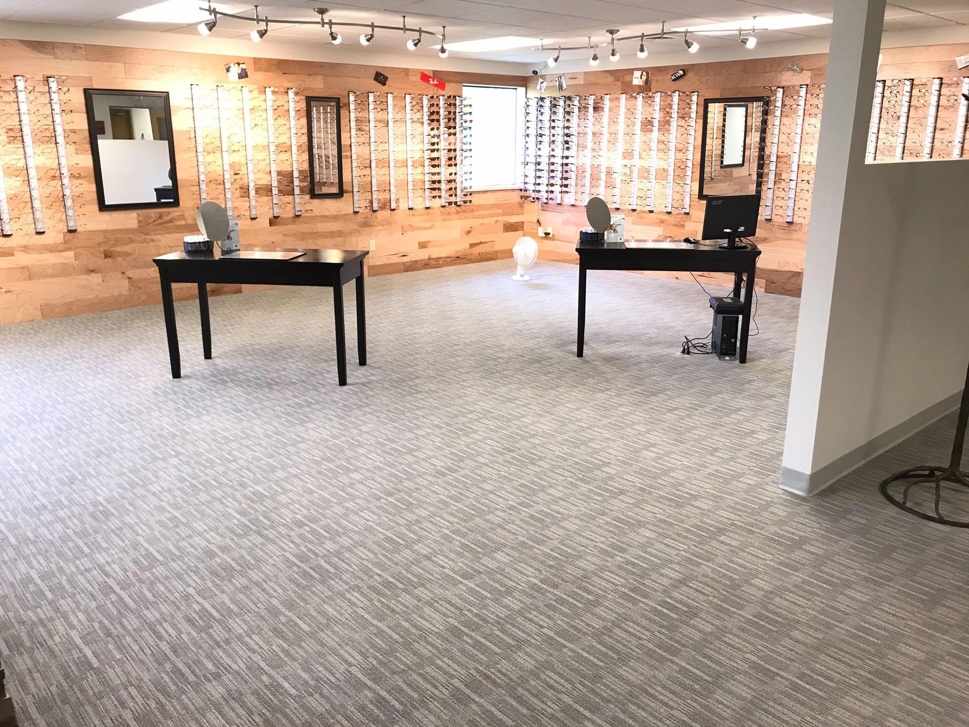 A large room with two tables and a computer in it