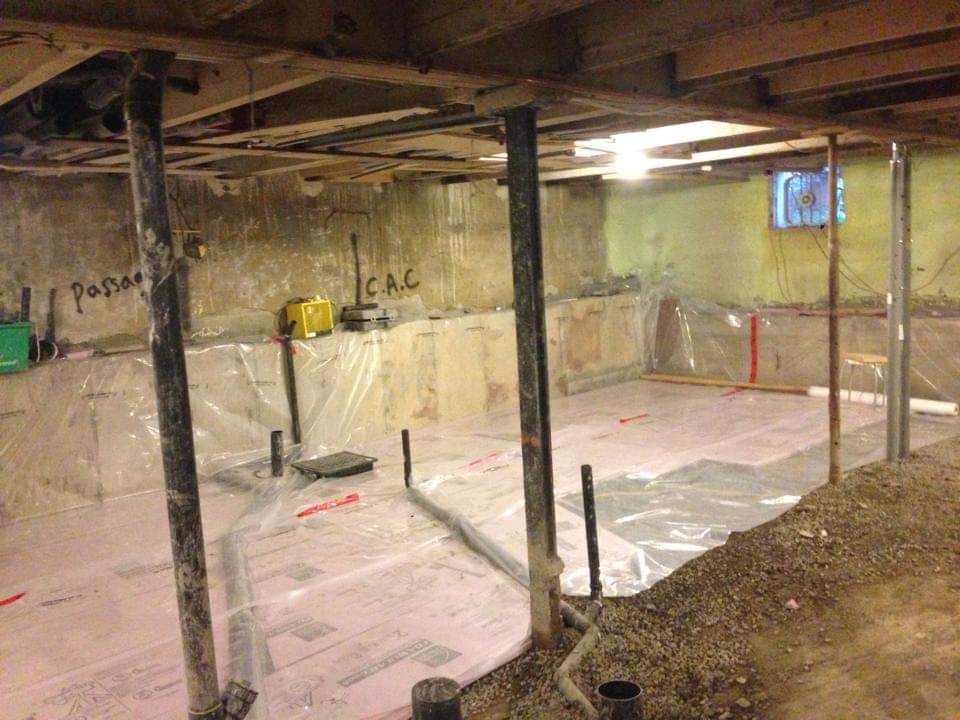 Un sous-sol est en cours de rénovation et recouvert de plastique.