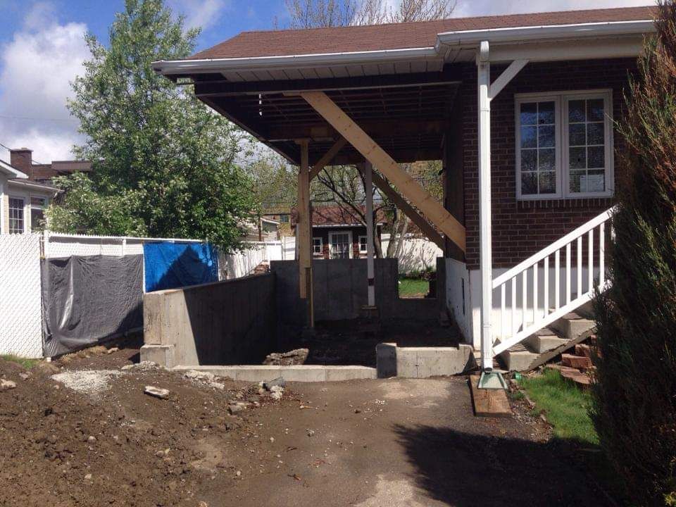Une maison avec un porche et des escaliers devant