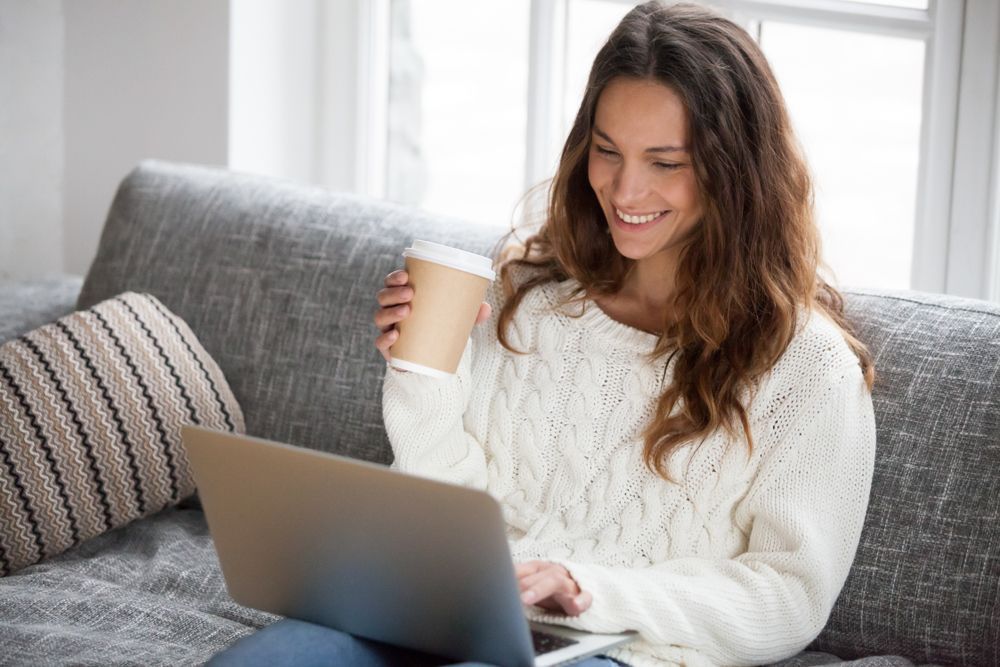 Woman Sitting On Computer Happy— Michael Andrews Taxation & Accounting Services In Pacific Paradise, QLD
