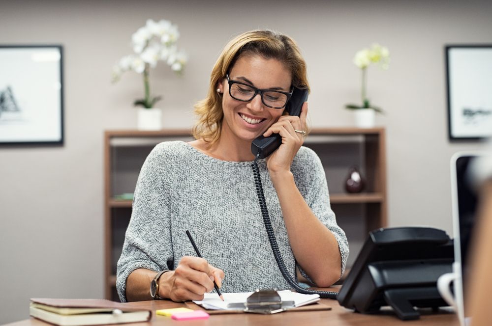 Business Woman On Phone — Michael Andrews Taxation & Accounting Services In Pacific Paradise, QLD