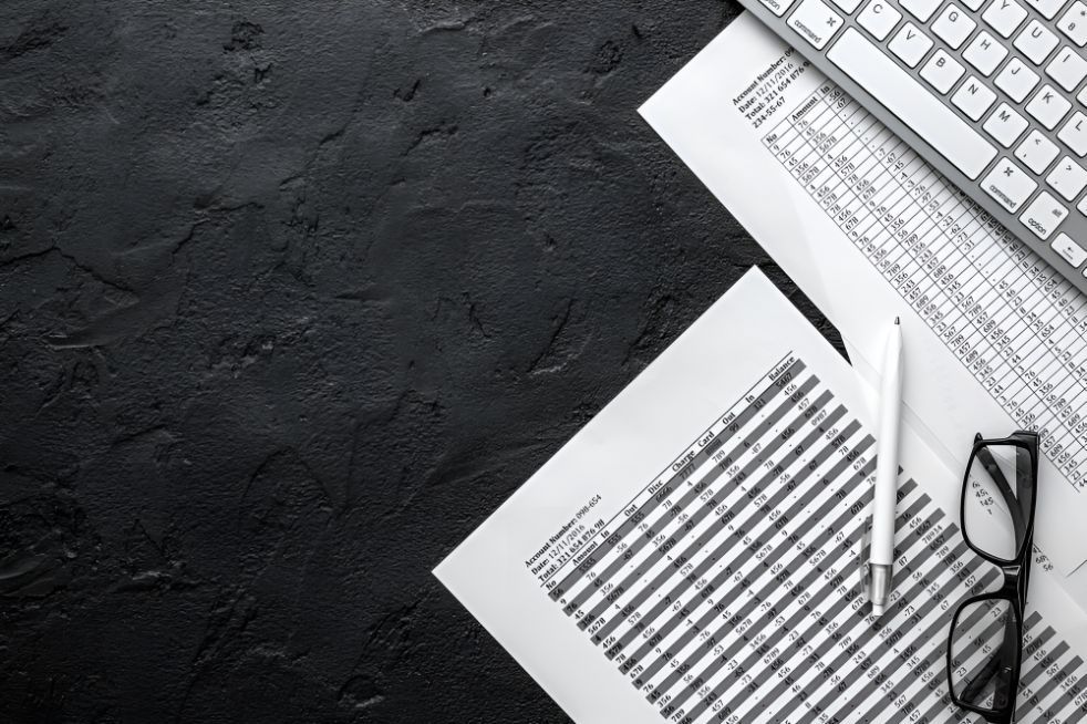 Pen, Glasses, Keyboard And Paper With A Table — Michael Andrews Taxation & Accounting Services In Pacific Paradise, QLD