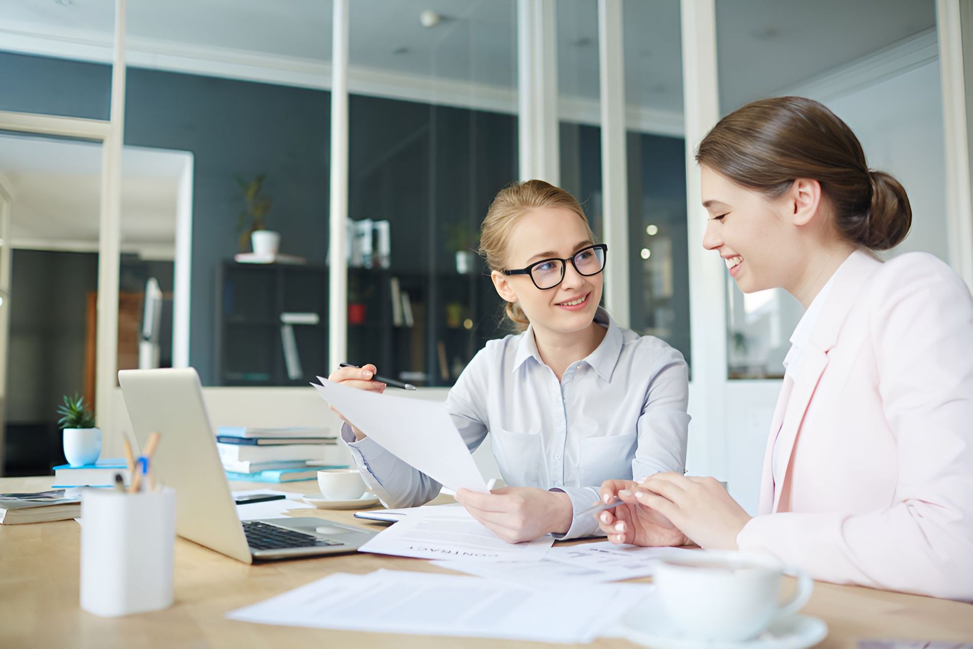 People Sitting At A Table With Papers — Michael Andrews Taxation & Accounting Services In Pacific Paradise, QLD