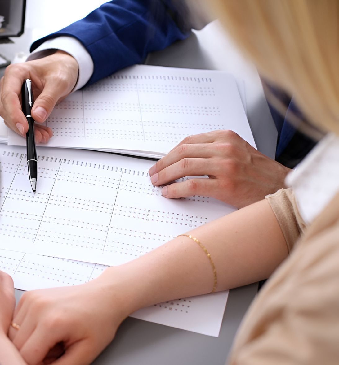 Man And Woman Writing On A Paper — Michael Andrews Taxation & Accounting Services In Pacific Paradise, QLD