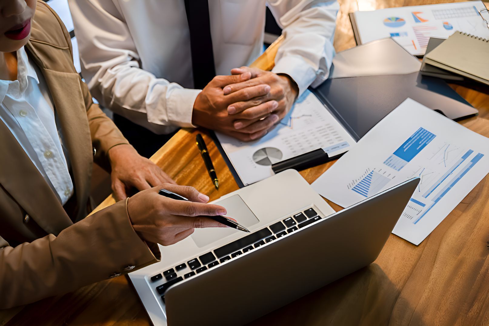 Sitting At A Table Looking At A Laptop Computer — Michael Andrews Taxation & Accounting Services In Maroochydore, QLD