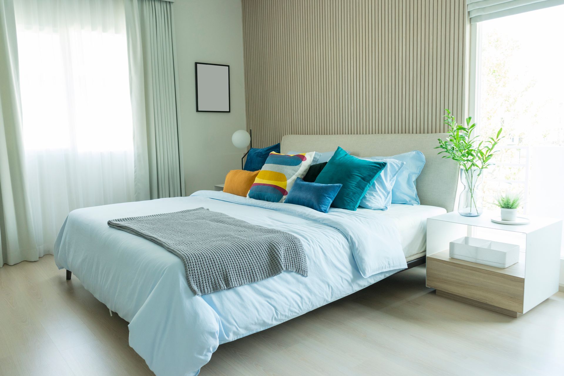 Modern and stylish bedroom with colorful bedding on bed.