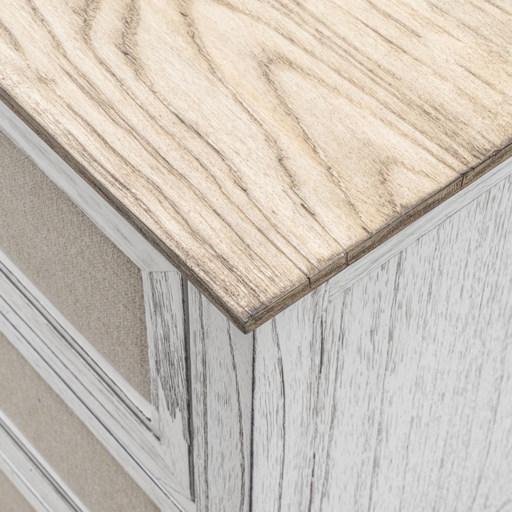 Captiva Island dresser features a coastal design with a distressed white and beach sand finish, six drawers adorned with outdoor fabric fronts, and woven knobs, presented in a close-up view.