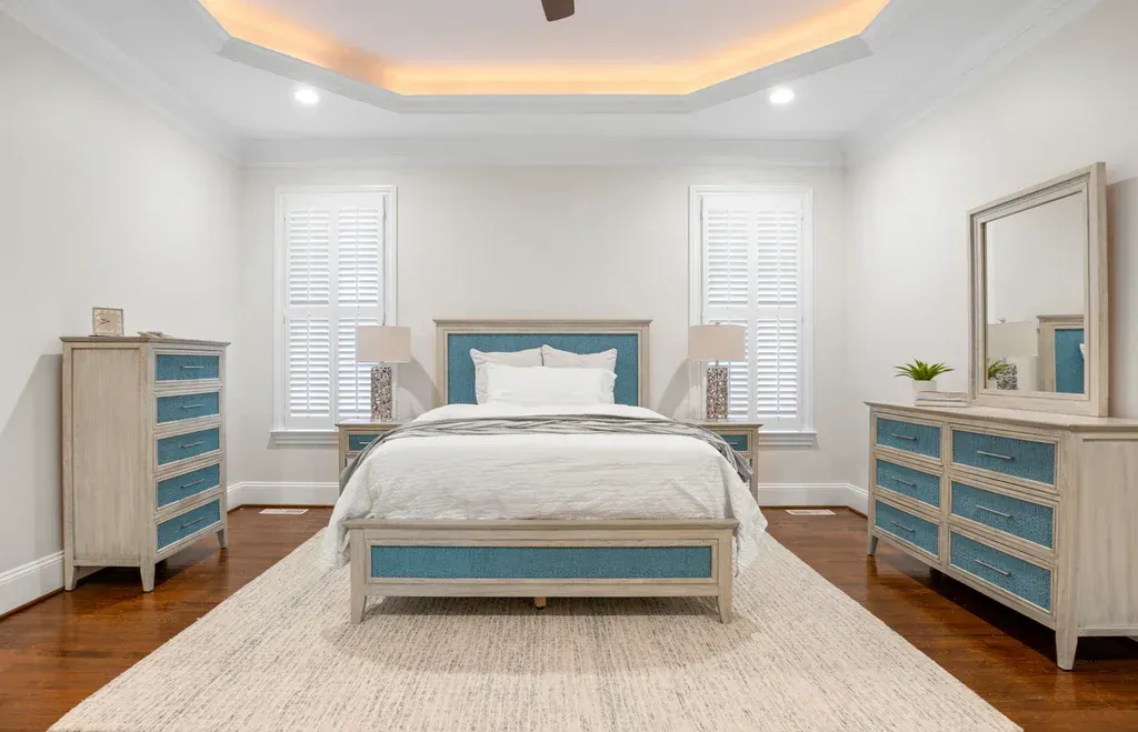 ocean isles bedroom collection is an aged ivory color with blue panels and drawer fronts.