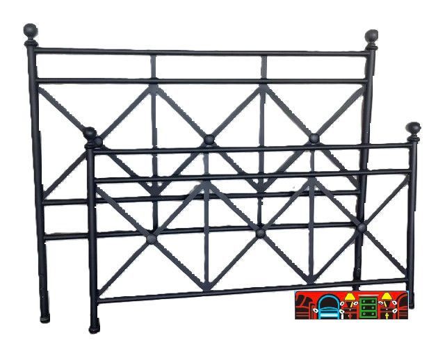 A queen-sized bed made of black metal and featuring a cross-shaped pattern.