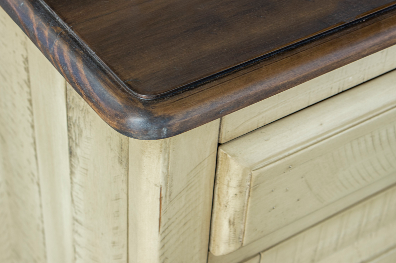 Brockton Dresser in solid wood, featuring a wheat color with a dark brown top, both with a distressed finish. Close-up view.