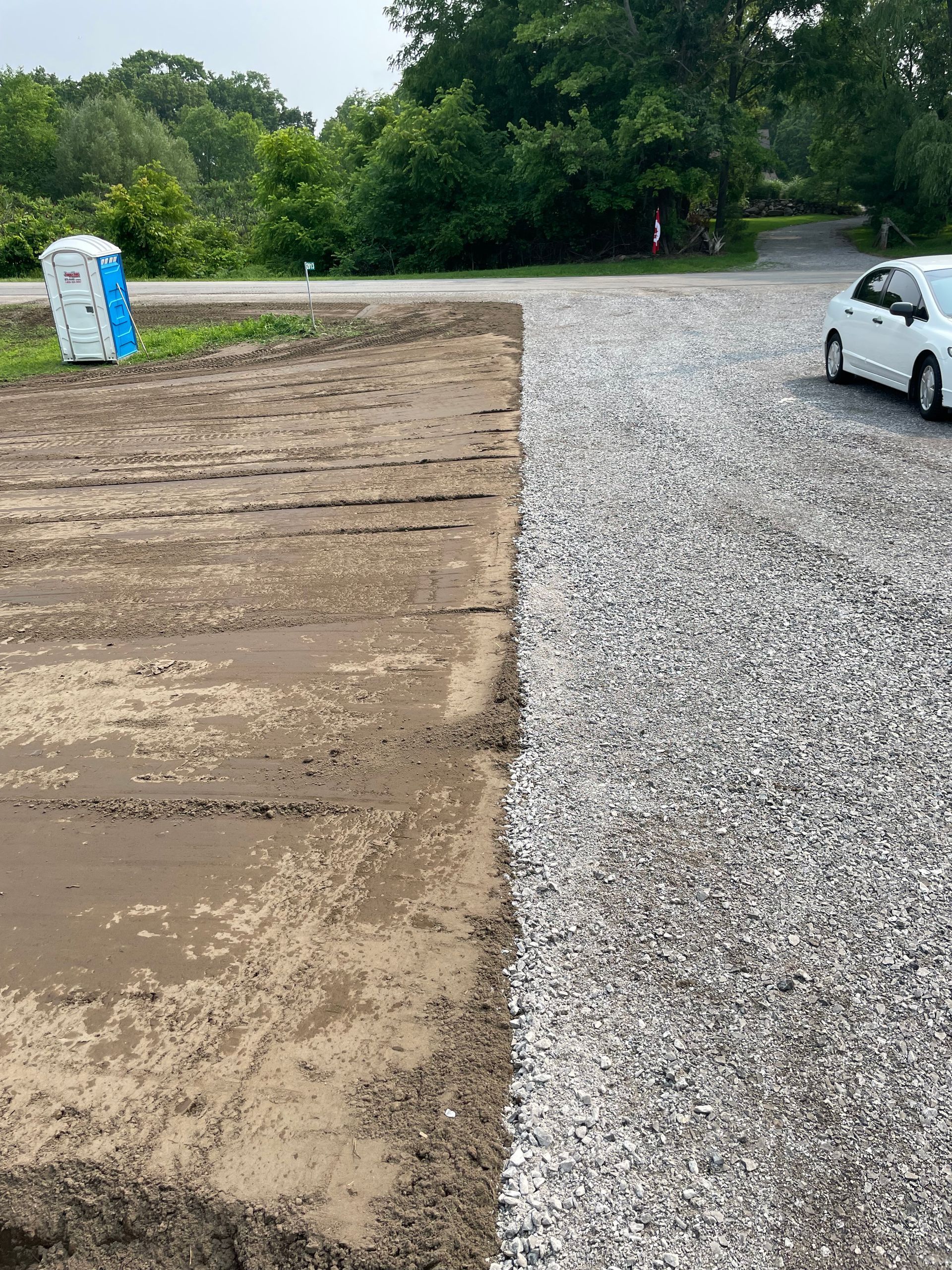 Excavator used to level driveway and yard. Fresh gravel trucked in for driveway