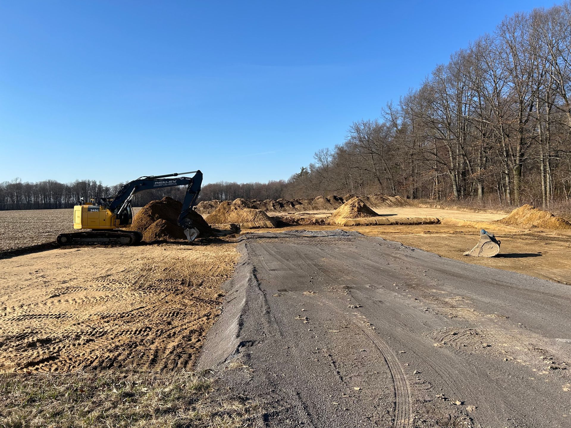 Driveway level and gravel with excavator.