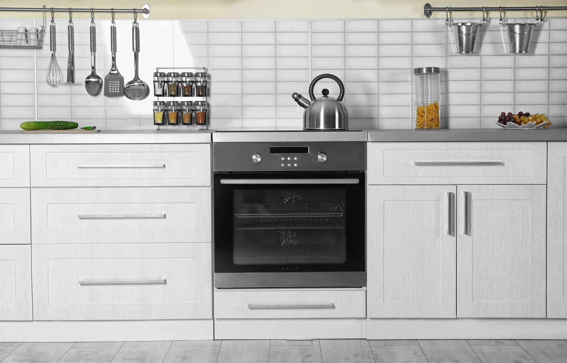 Laundry room with two white washing machines, laundry basket, and detergent.