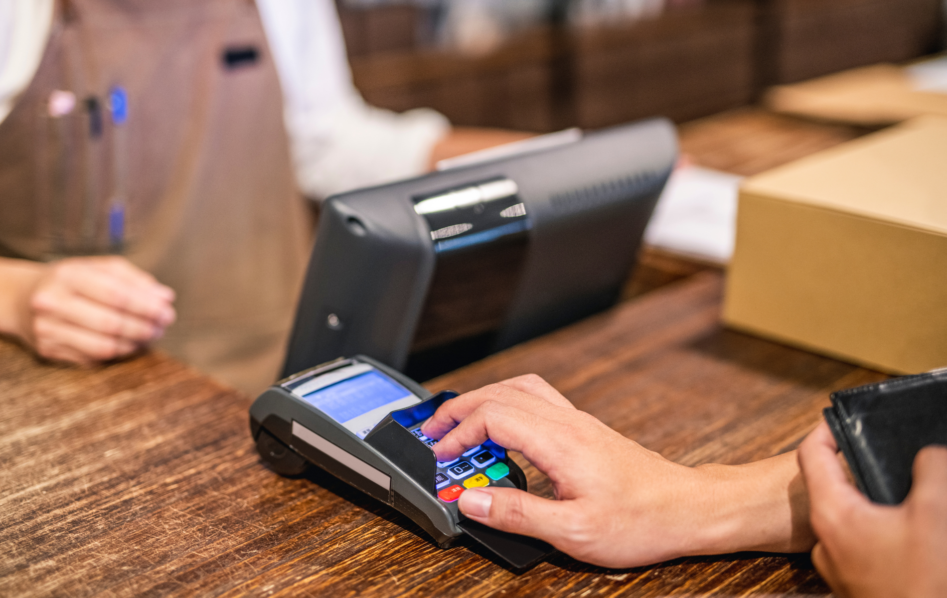 A person is using a credit card machine to pay for something.