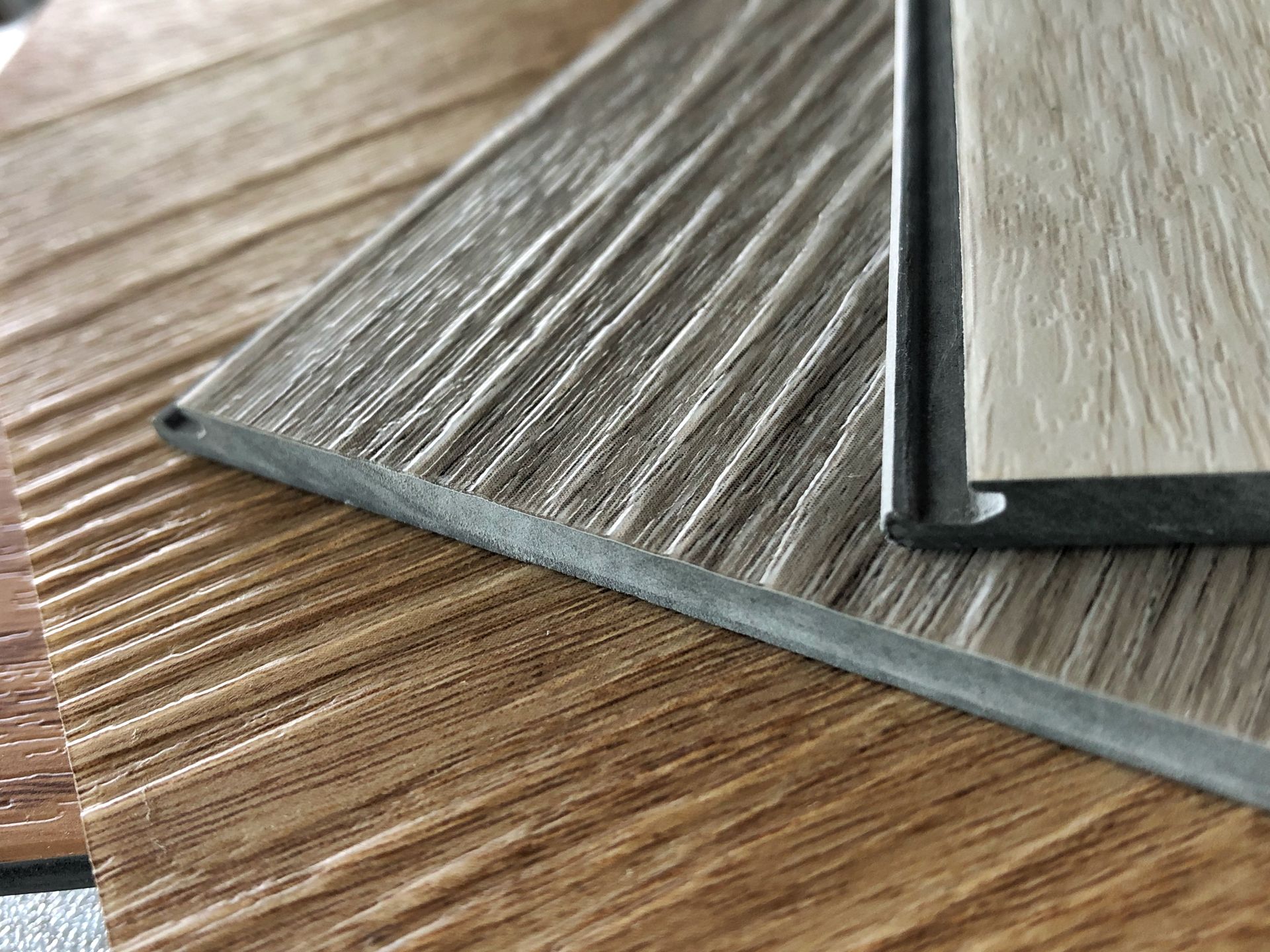 Two pieces of wood are sitting on top of each other on a table.