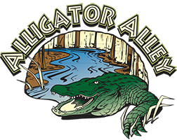 A green alligator rests in a swamp with the words 