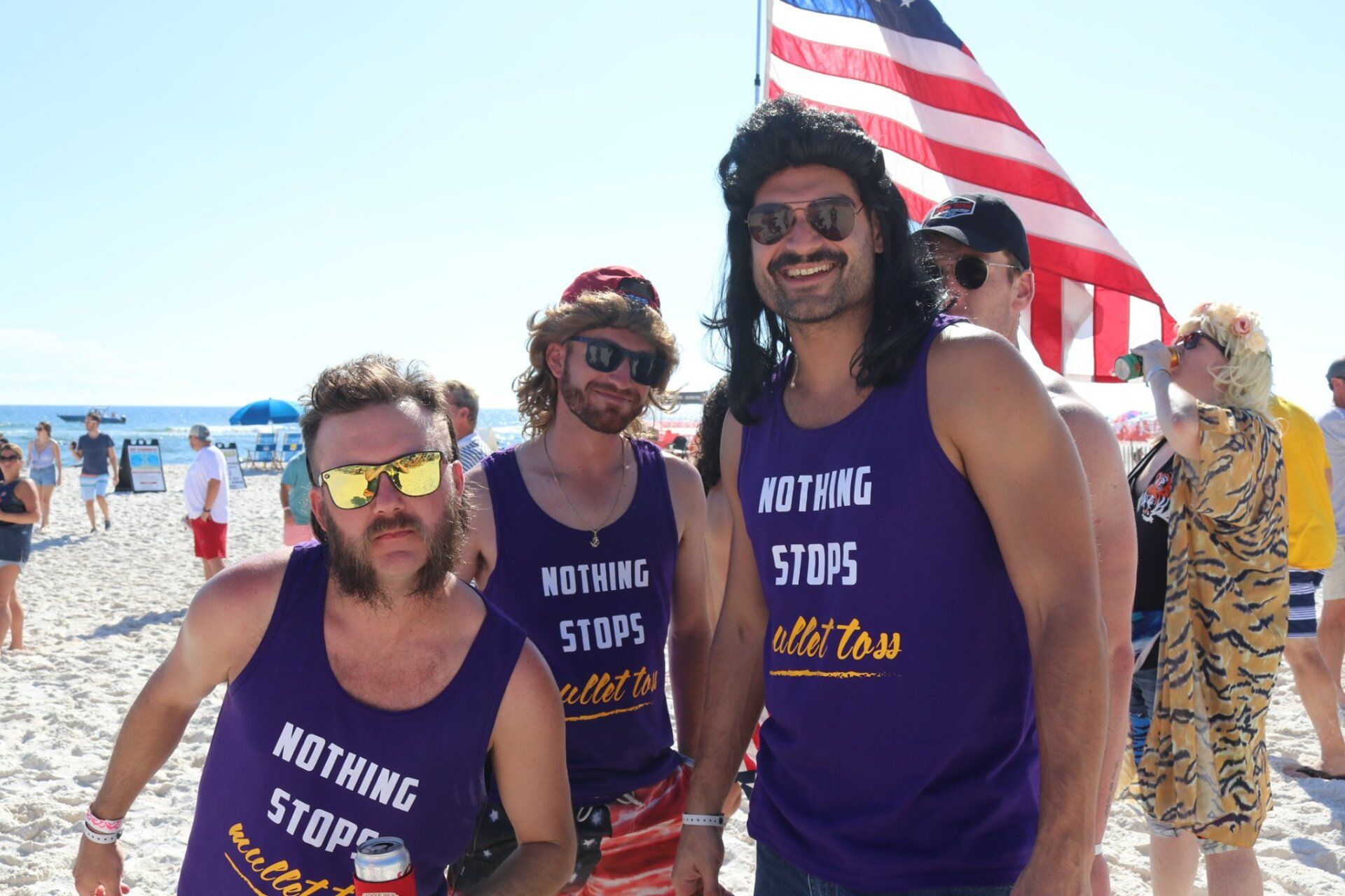 Three people with mullets and sunglasses wearing purple 
