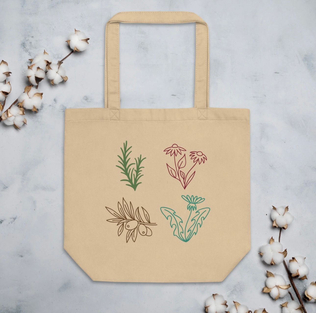 Beige tote bag with embroidered herbs: rosemary, mushrooms, olives, and dandelion.