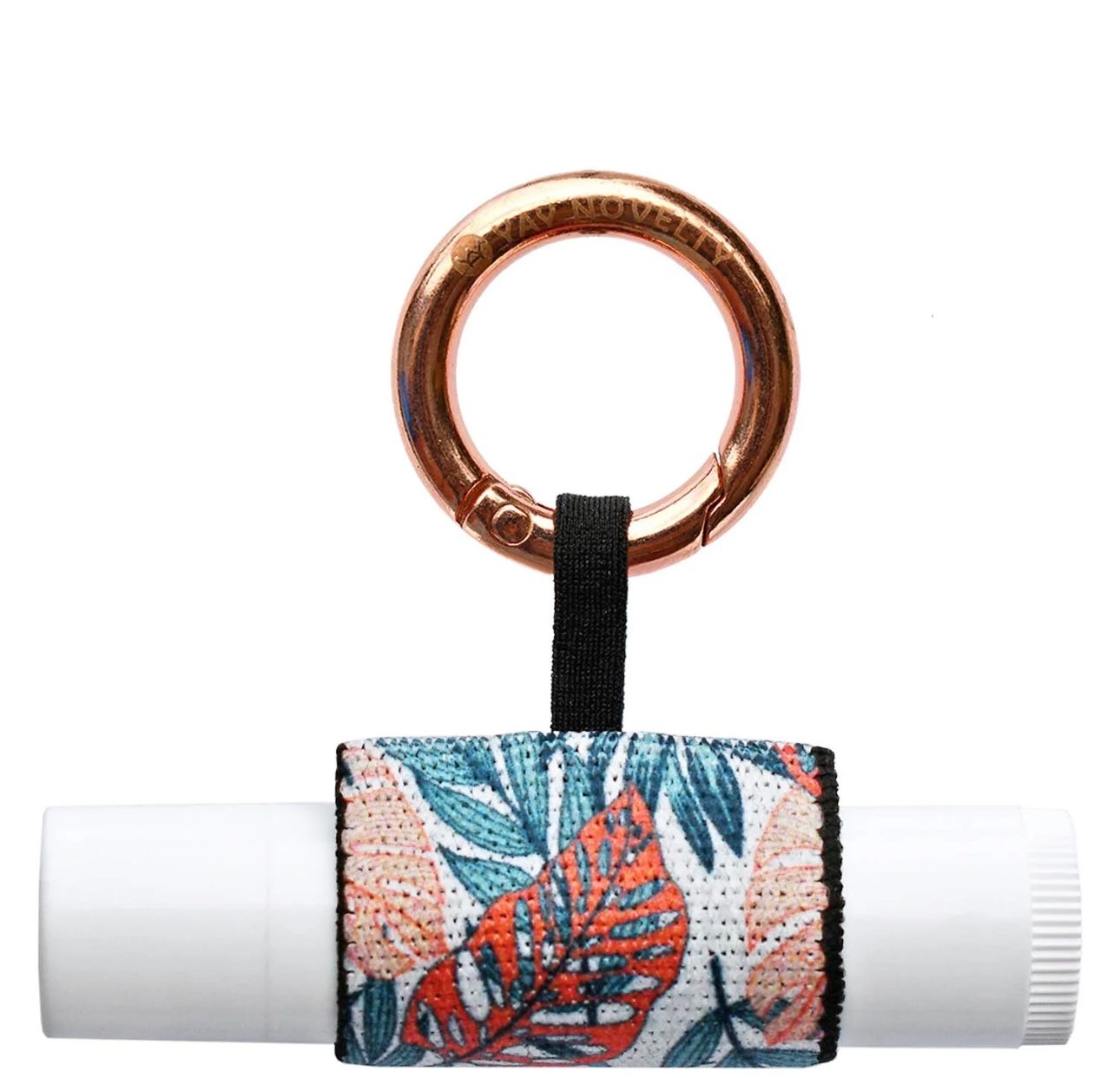 Lip balm holder with floral print wrapped around a white tube, attached to a rose gold ring.